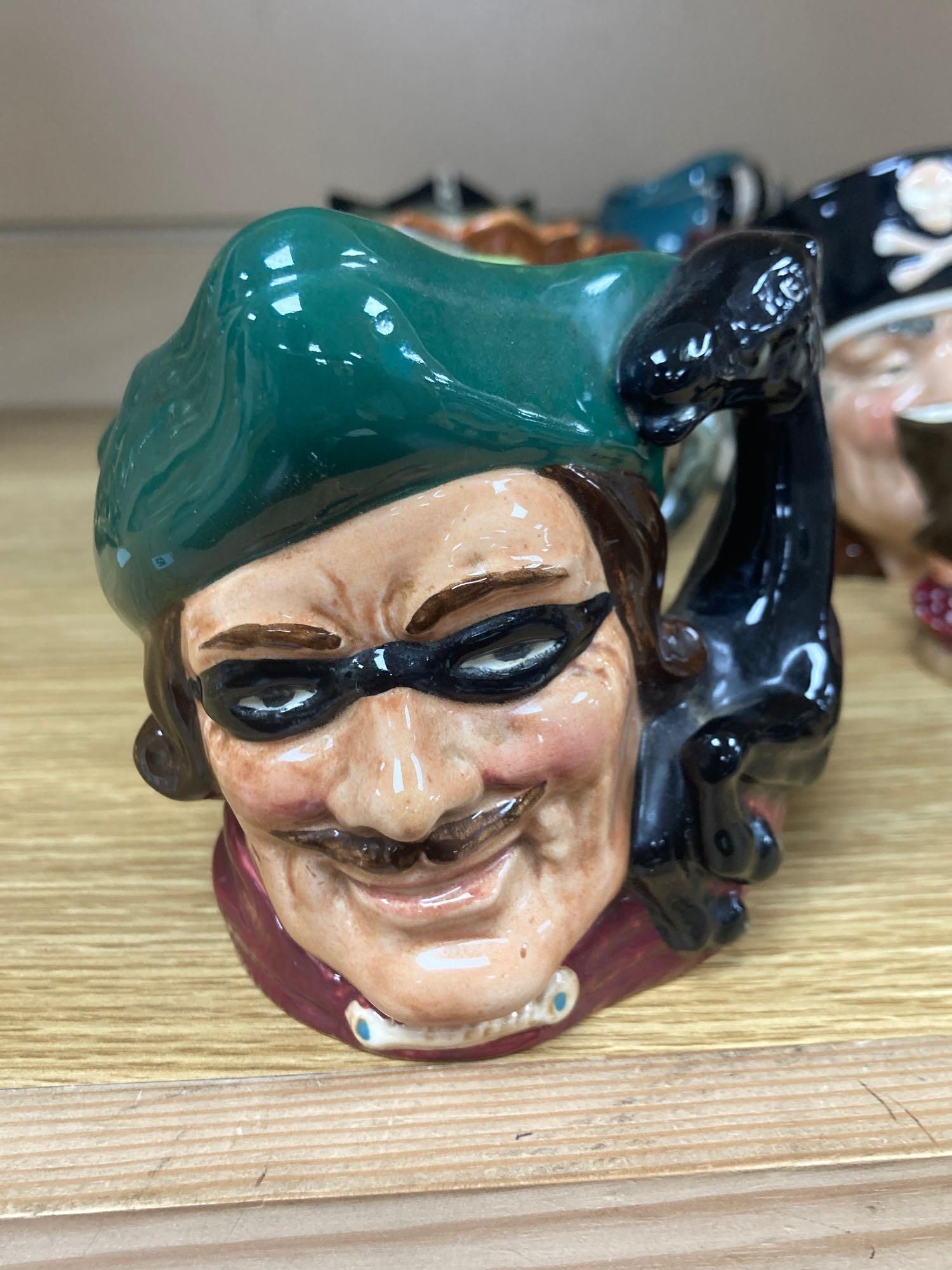 Eight Royal Doulton medium character jugs and seventeen Royal Doulton small character jugs (25)